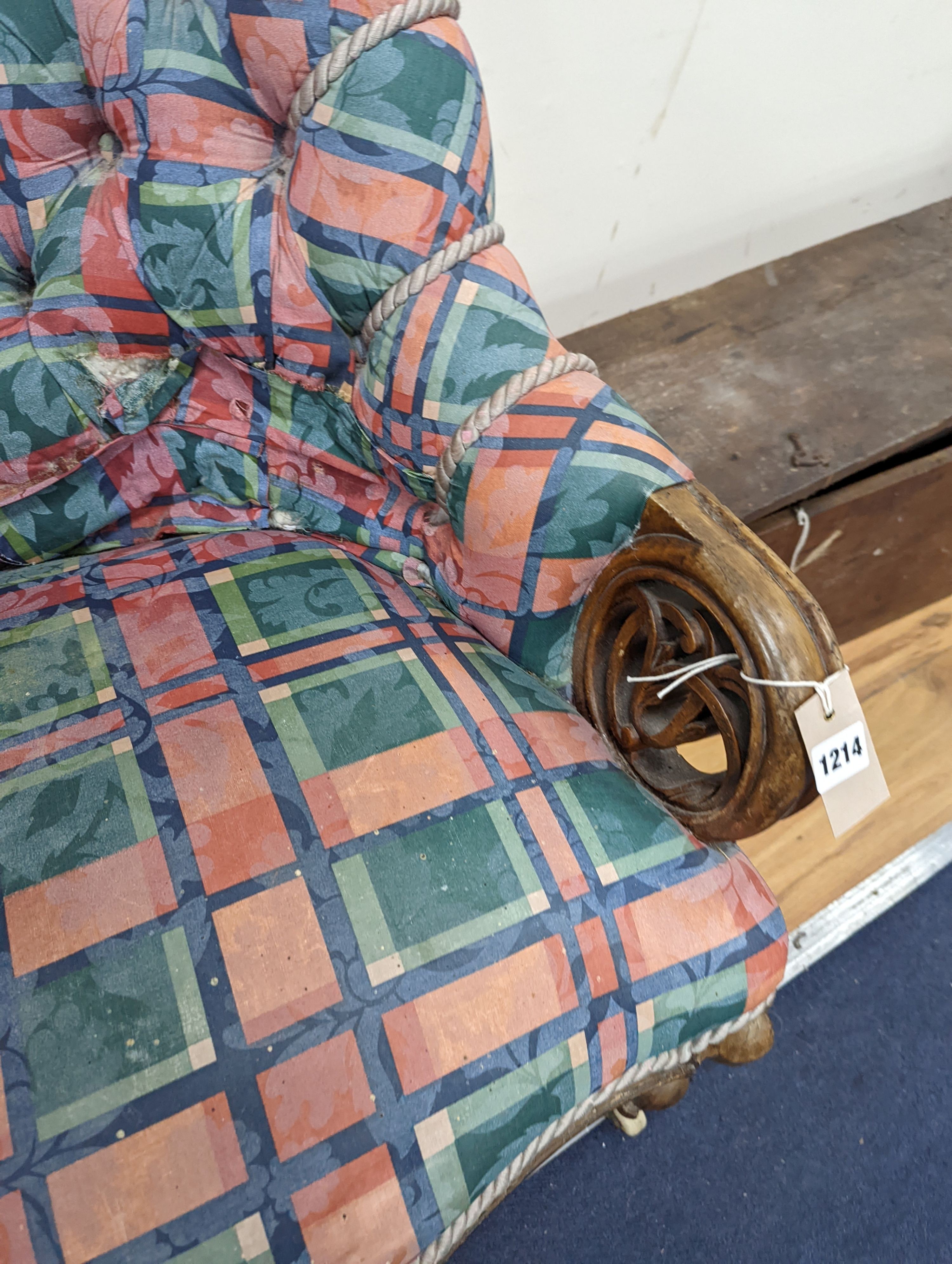 A Victorian carved walnut button back armchair